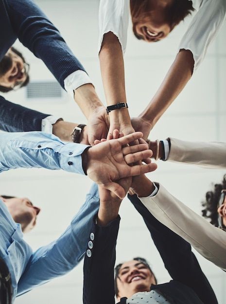 Equipe unindo as mãos em sinal de colaboração